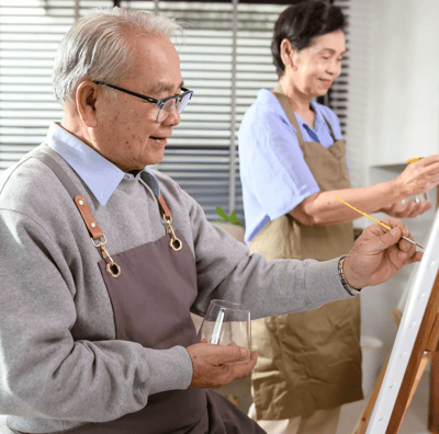 Elderly residents engaged in an art activity.