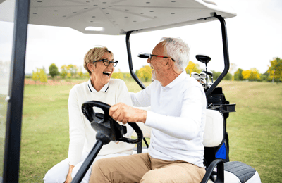 Older adults enjoying a joyful moment in a golf cart