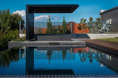 Modern outdoor pool area with reflections.
