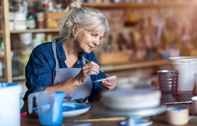 Senior woman engaging in a creative activity.
