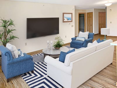 Cozy living room area with blue furniture.