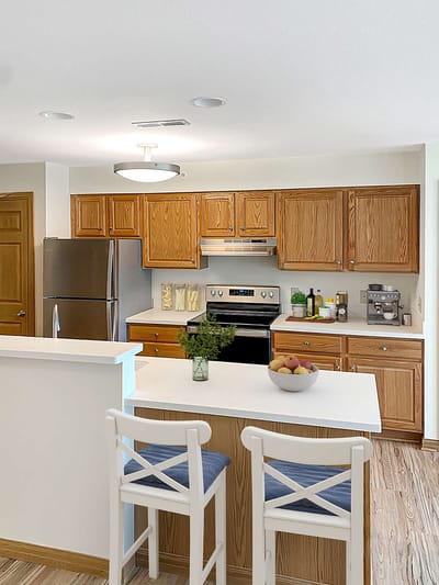 Bright kitchen space with seating and food items.