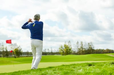Senior playing golf on a sunny day