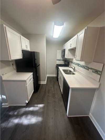 Modern kitchen with new appliances and cabinetry.