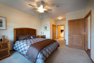 Cozy bedroom with a bed and wooden furniture.