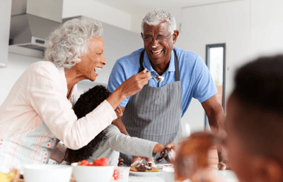 Seniors sharing a meal with family in a kitchen