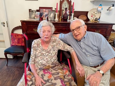 Two elderly residents sitting together in a cozy room