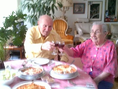 Two residents sharing a toast over dinner