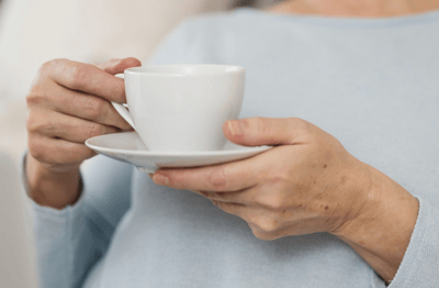 Close-up of a person's hands holding a cup of tea