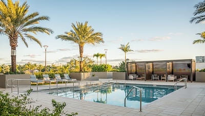 Resort-style outdoor pool area with palm trees