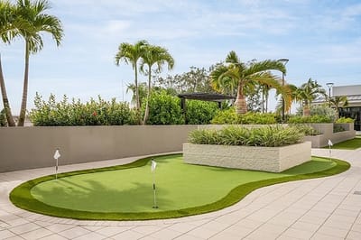 Beautiful outdoor putting green with landscaping