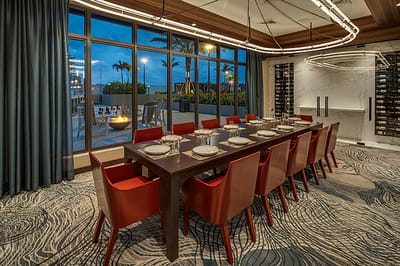 Elegant dining room with large communal table and outdoor view