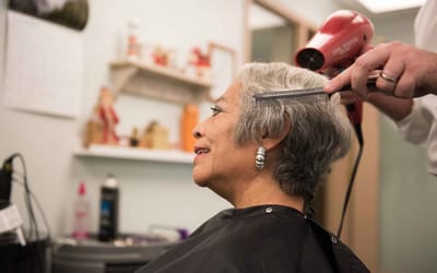 Resident receiving a haircut in the salon