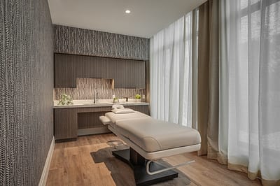 Therapy room with a massage table and soft lighting
