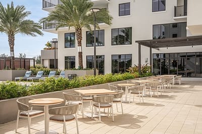Outdoor dining area with seating and pool view