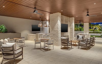 Outdoor lounge area with seating and TVs