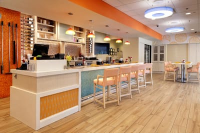 Bright, modern dining area with a bar and seating