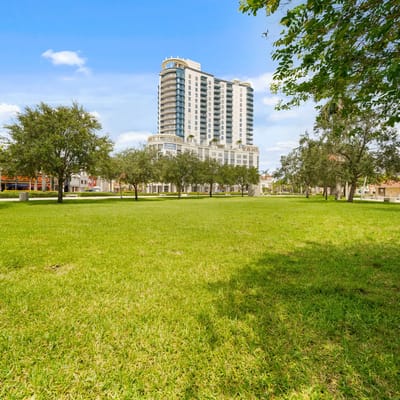 Outdoor area with grassy space and building in the background