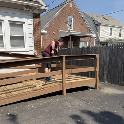 Person working on a wooden ramp outside