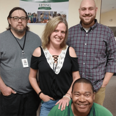 Staff members smiling in a communal area