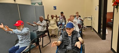 Residents participating in a seated activity session