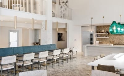 Bright, modern common area with seating and kitchen