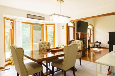 Bright dining area with large windows and wooden table