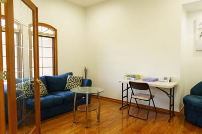 Bright interior room with seating and a table