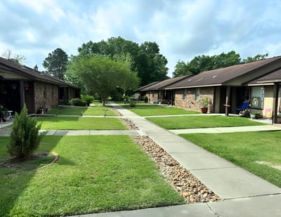 Pathway between residential buildings with green lawns