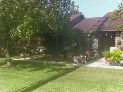 Front exterior of a senior living facility with gardens
