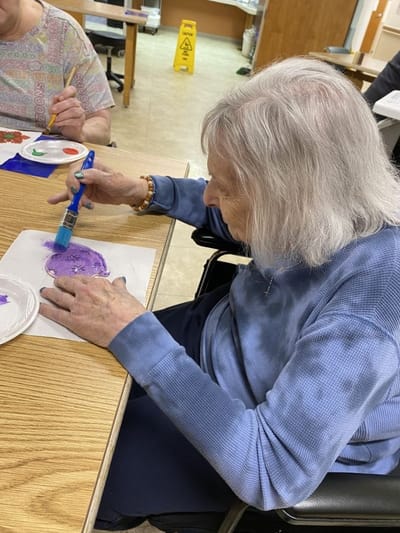 Resident painting during an activity session