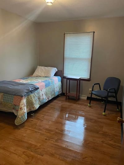 Cozy resident room with a bed and chair