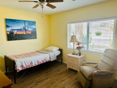 A cozy resident room with a bed and window view