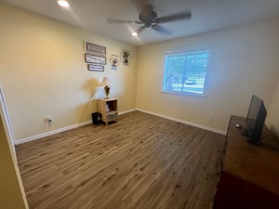 Interior view of a private room with wooden floors and light walls