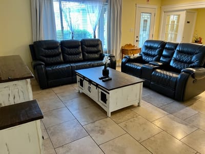 Cozy living room area with black sofas and a coffee table