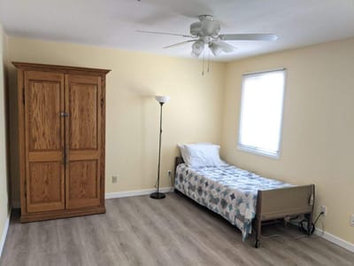 Private resident room with a bed and dresser