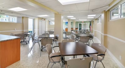 Interior view of a dining room with tables and chairs
