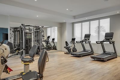 Interior gym with exercise equipment and natural light
