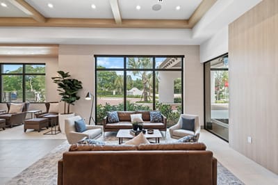 Bright common area with modern furniture and large windows