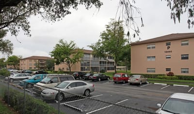 Exterior view of Hawthorne Condominium with parking area