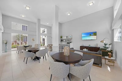 Bright interior of a common area with seating and TV