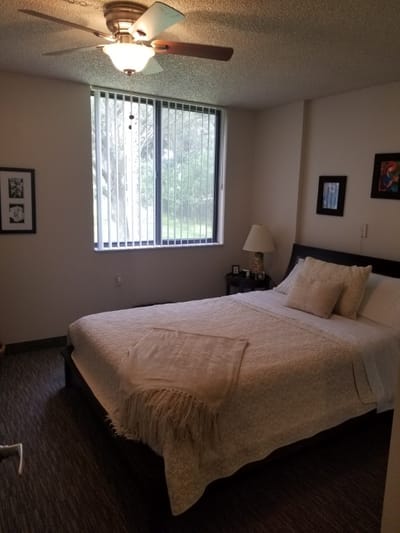 A cozy private resident room with a bed and window