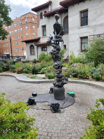 Outdoor sculpture surrounded by landscaped gardens