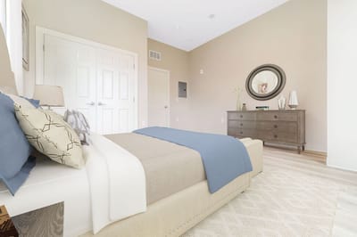 A well-furnished resident room with a bed and dresser