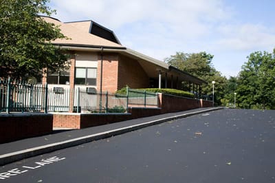 Exterior view of the facility building with landscaped area
