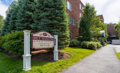 Exterior view of Bet Shalom Senior Apartments with sign