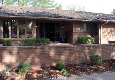Exterior view of the facility building with landscaping
