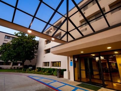 Entrance of Cedar Hills Senior Apartments with glass canopy