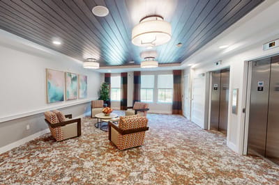 Cozy common area with seating and elevators