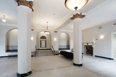 Spacious lobby area with decorative columns and seating